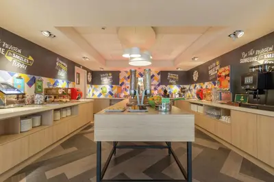 a fast food restaurant with a table in the middle at Hampton By Hilton Antwerp Central Station in Antwerp