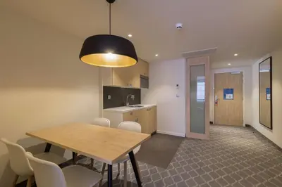 a kitchen and dining room with a table and chairs at Hampton By Hilton Antwerp Central Station in Antwerp