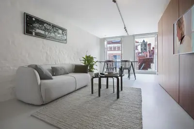 a living room with a couch and a table at Snooz Ap Holiday & Business Flats in Ghent