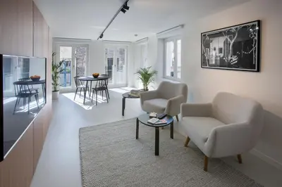 a living room with two chairs and a table at Snooz Ap Holiday & Business Flats in Ghent