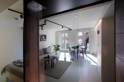 a living room with a couch and a table at Snooz Ap Holiday & Business Flats in Ghent