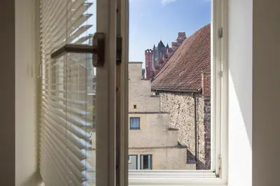 an open window with a view of buildings at Snooz Ap Holiday & Business Flats in Ghent