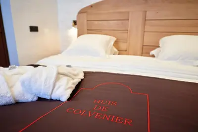 a bed with a sign that reads his de controller at Hotel Colvenier in Antwerp