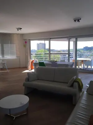 a living room with a couch and a table at Scheldepunt in Ghent