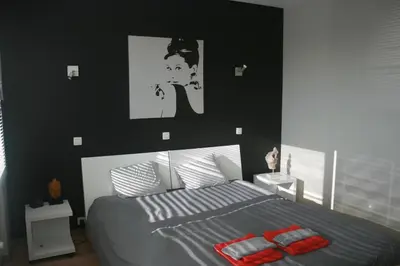 a bedroom with a bed with two red towels on it at Scheldepunt in Ghent