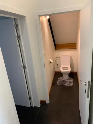 a small bathroom with a toilet in a room at Rap 'n Holiday Home in Sint-Denijs-Westrem