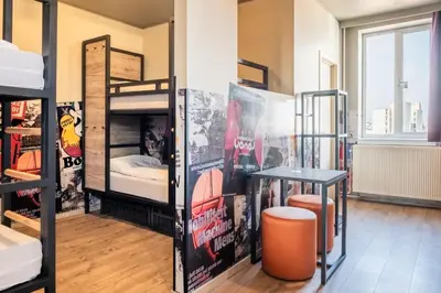 a room with bunk beds and a table at a&o Antwerpen Centraal in Antwerp