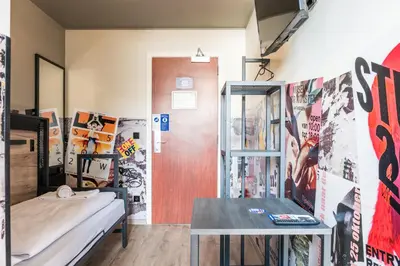 a room with bunk beds and a table at a&o Antwerpen Centraal in Antwerp
