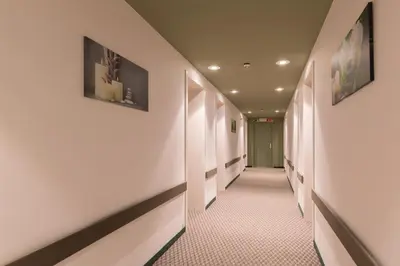 a corridor of a hospital hallway with white walls at a&o Antwerpen Centraal in Antwerp