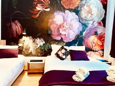 a bedroom with two beds and a flower mural at Hotel Du Parlement in Brussels