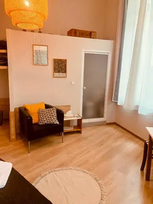 a living room with a couch and a table at Hotel Du Parlement in Brussels