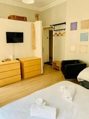 a hotel room with a bed and a tv at Hotel Du Parlement in Brussels