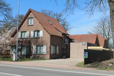 a brick house on the side of a street at Guesthouse De Casteleer in Kasterlee