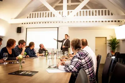 a group of people sitting around a table in a meeting at Guesthouse De Casteleer in Kasterlee