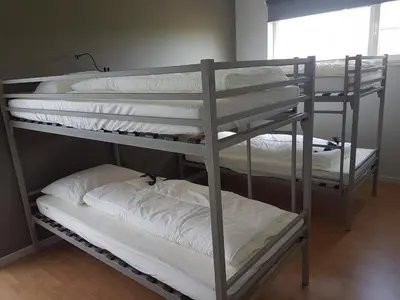 two bunk beds in a room with white pillows at De Schaapskooi in Kasterlee