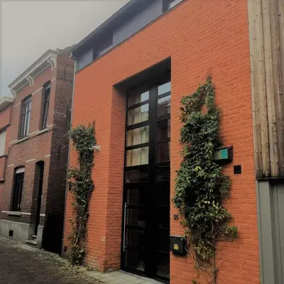 a brick building with plants on the side of it at B&B Wannes Suite in Leuven