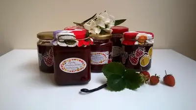 a group of four jars of jam and strawberries at B&B Wannes Suite in Leuven