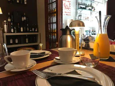 a table with plates and utensils on a table at Atelier 24 in Sint-Pieters-Leeuw