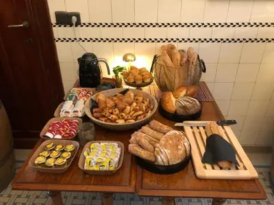a table topped with lots of different types of bread at Atelier 24 in Sint-Pieters-Leeuw