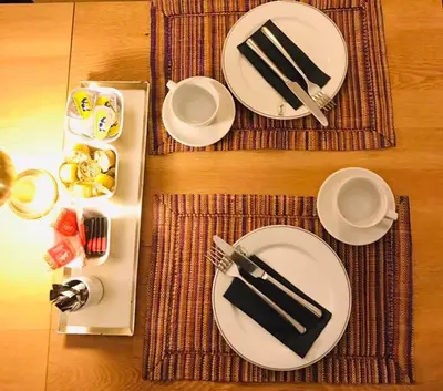 a table with plates and utensils on a table at Atelier 24 in Sint-Pieters-Leeuw