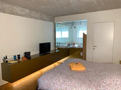 a bedroom with a bed and a television in it at B&B Yellow Submarine in Antwerp