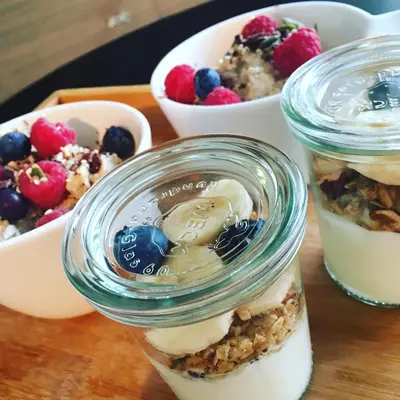 three jars of dessert with berries and a bowl of food at B&B Yellow Submarine in Antwerp