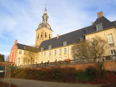 a large building with a tower and a church at Studio's Park - Heverlee in Leuven