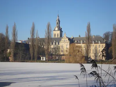 a large building with a clock tower on top of it at Studio's Park - Heverlee in Leuven