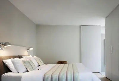 a bedroom with a large white bed with white pillows at midiSud Apartment in Ghent