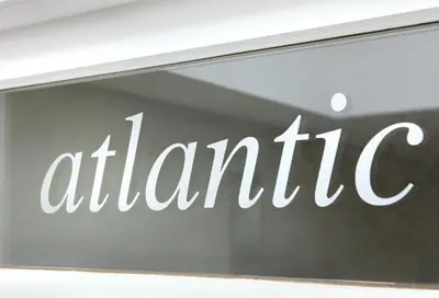 a glass window with the wordatlantic written on it at midiSud Apartment in Ghent