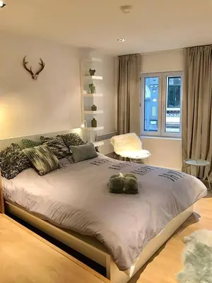 a bedroom with a large bed and a window at Your suite Ghent in Ghent