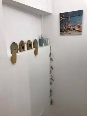 a white wall with a shelf with bird figurines on it at Your suite Ghent in Ghent