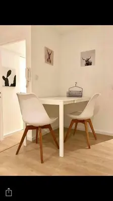 a white table and two white chairs in a room at Your suite Ghent in Ghent