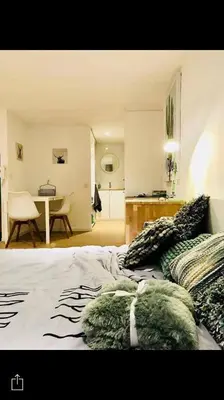 a bedroom with a bed with pillows and a table at Your suite Ghent in Ghent