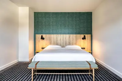 a bedroom with a bed and a green headboard at Radisson Hotel Brussels Centre Midi in Brussels