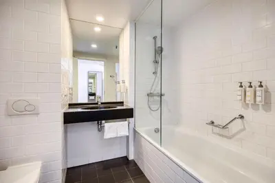 a bathroom with a shower and a sink at Radisson Hotel Brussels Centre Midi in Brussels