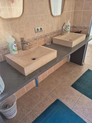 a bathroom counter with two sinks and a mirror at Les Pieds a La Grande Place in Brussels