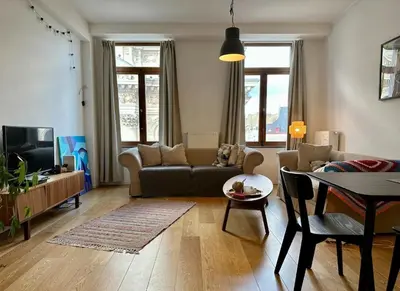 a living room with a couch and a table at Les Pieds a La Grande Place in Brussels
