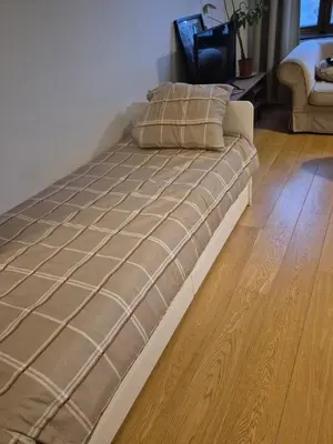 a large bed in a room with a wooden floor at Les Pieds a La Grande Place in Brussels