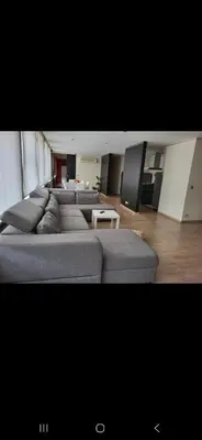 a large living room with couches and a tv at Les Pieds a La Grande Place in Brussels