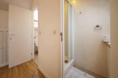 a bathroom with a shower and a glass door at B&B Le Lys d'or in Brussels