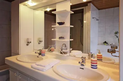 a bathroom with two sinks and a large mirror at B&B Le Lys d'or in Brussels