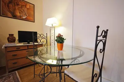 a glass table with a vase of flowers on it at B&B Le Lys d'or in Brussels