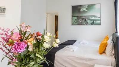 a room with a bed and flowers on the floor at Albert gare du Midi , 29 in Brussels