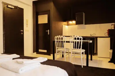a bedroom with a bed and a table and chairs at Albert gare du Midi , 29 in Brussels