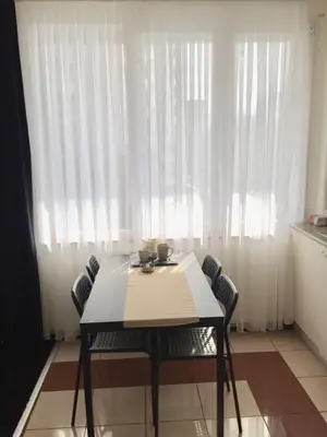 a dining room table with chairs in front of a window at Albert gare du Midi , 29 in Brussels