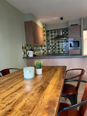 a wooden table in a kitchen with chairs at Antwerp City Appartment in Antwerp