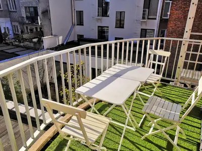 two chairs and a table on a balcony at Antwerp City Appartment in Antwerp