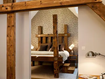 a bedroom with a wooden bunk bed in a room at Aspria Royal La Rasante Hotel & Spa in Brussels