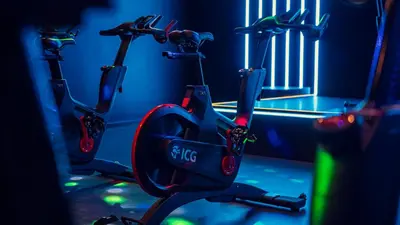 a gym with two exercise bikes parked next to a gate at Aspria Royal La Rasante Hotel & Spa in Brussels